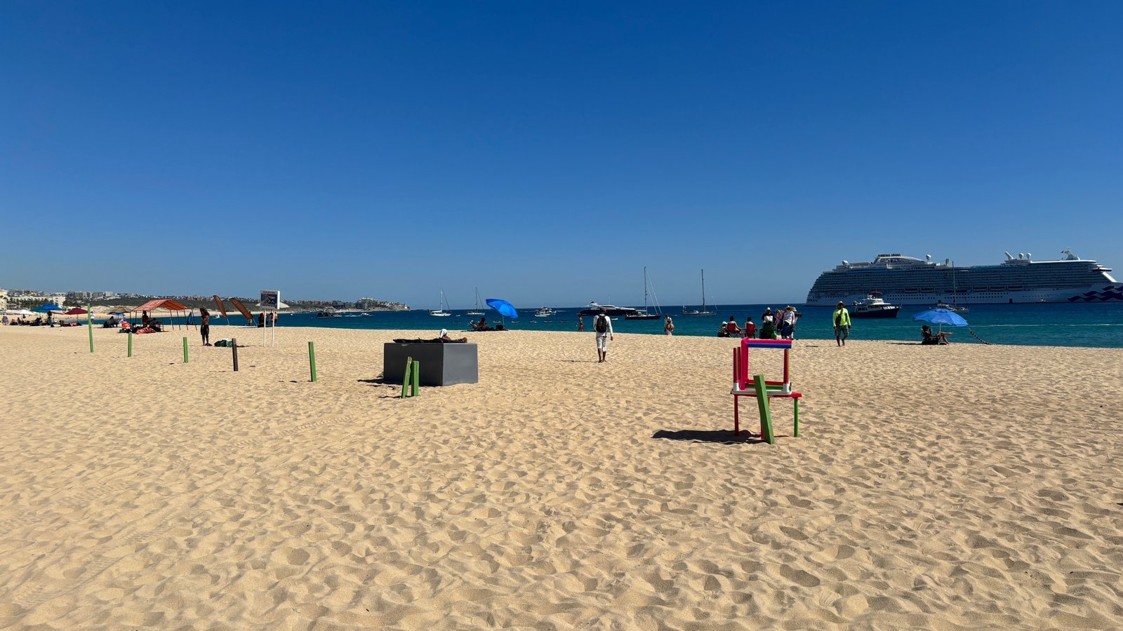 Snorkelers above white sand and reef fish at Chileno Bay