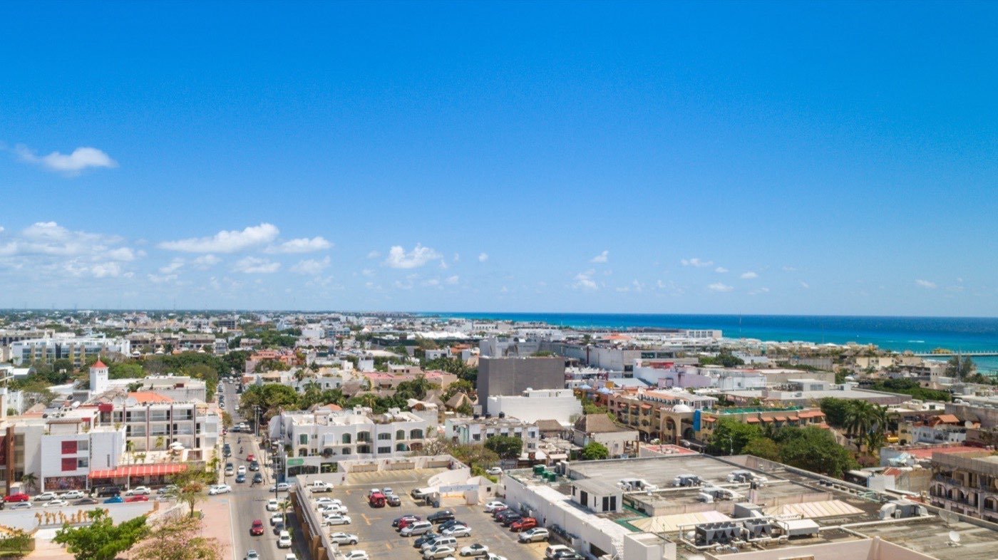 Yacht moored off Cozumel reef with snorkelers in turquoise water