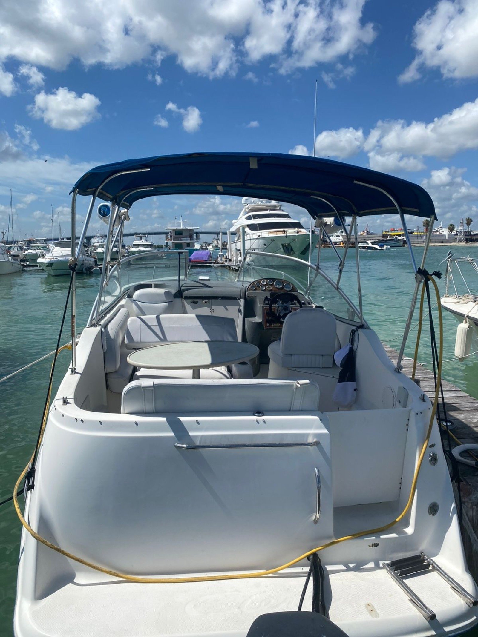 Bayliner 25 ft coastal cruiser moored at Marina Yucalpetén in Progreso Yucatán with Gulf of Mexico visible in the background