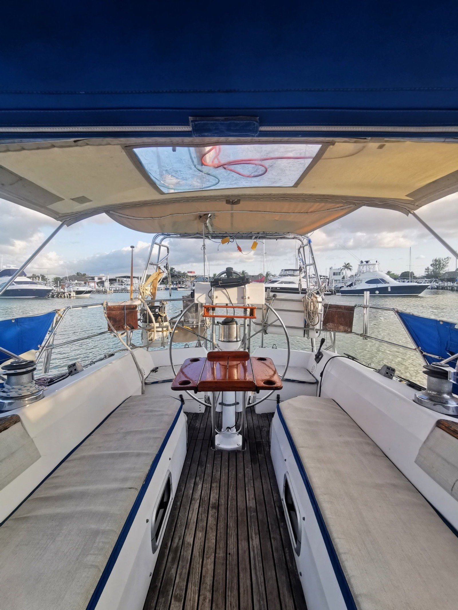 Catalina 42 ft sailing yacht with unfurled white sails off Marina Yucalpetén, Progreso Yucatán
