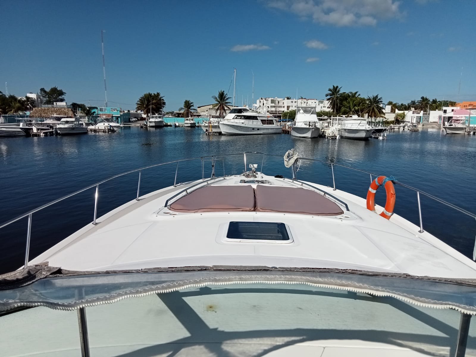 Sea Ray 48 ft Sundancer yacht with large swim platform anchored off Progreso Yucatán for a private charter