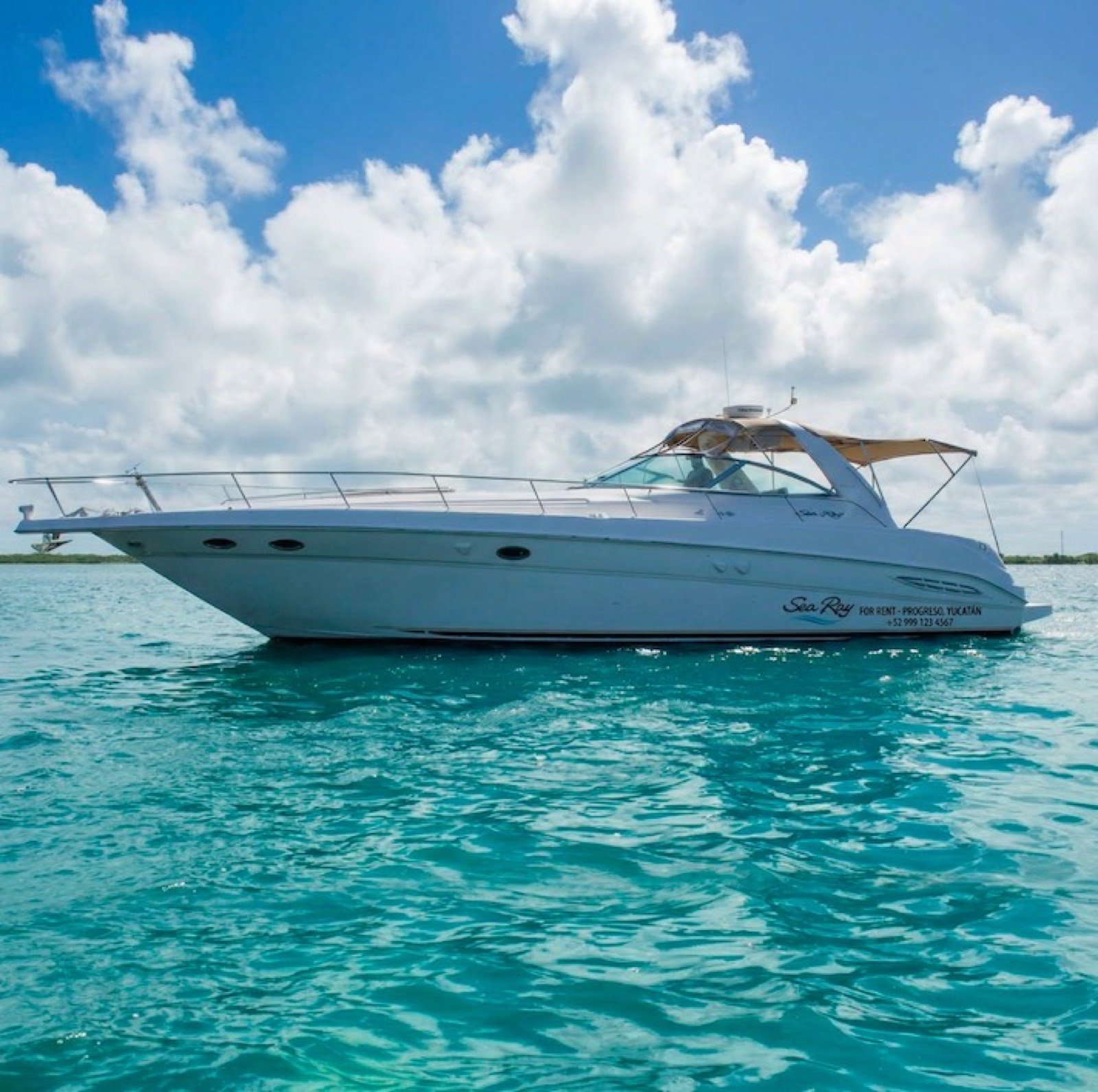 Sea Ray 48 ft Sundancer yacht with large swim platform anchored off Progreso Yucatán for a private charter